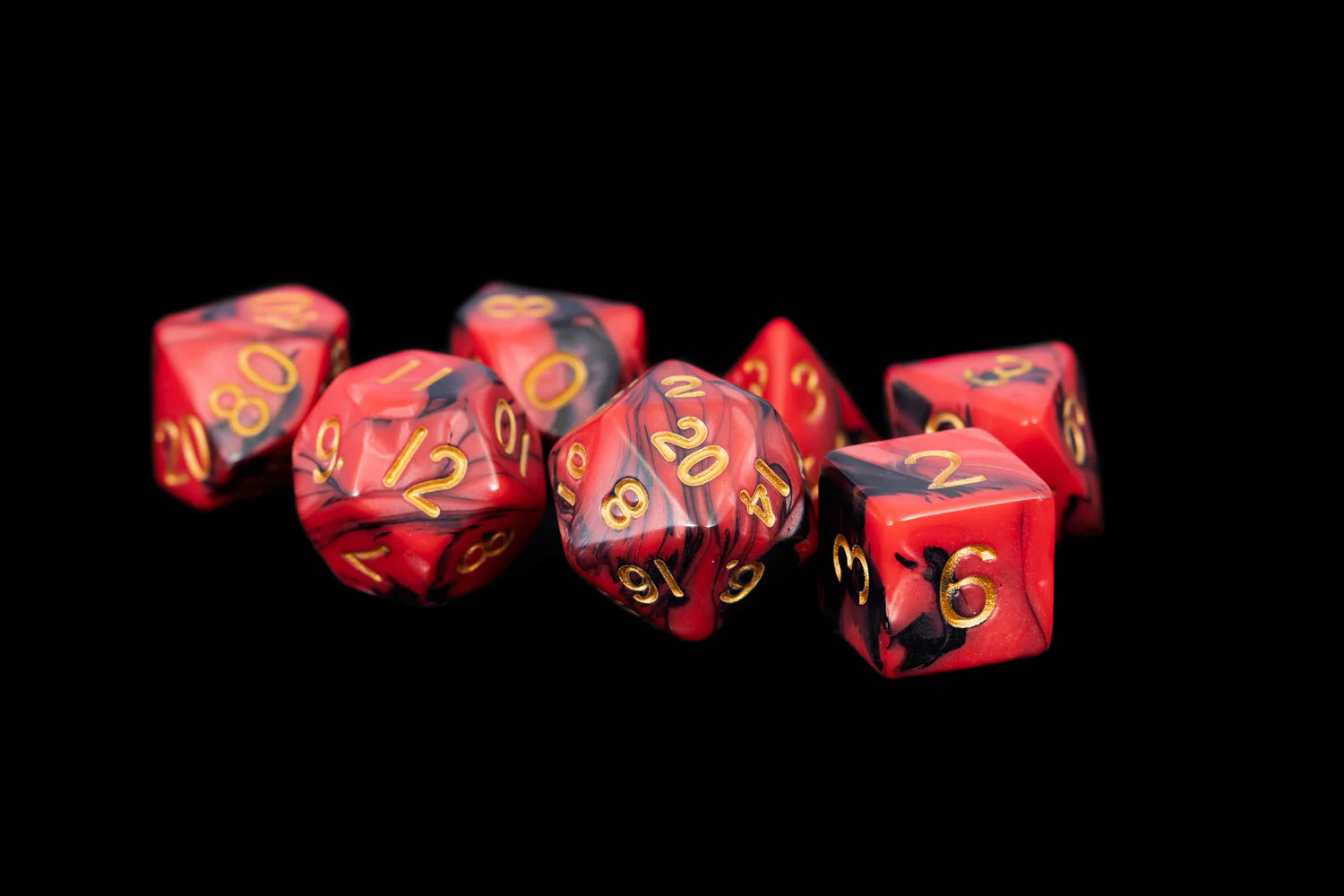 Red polyhedral dice with black accents on a black background